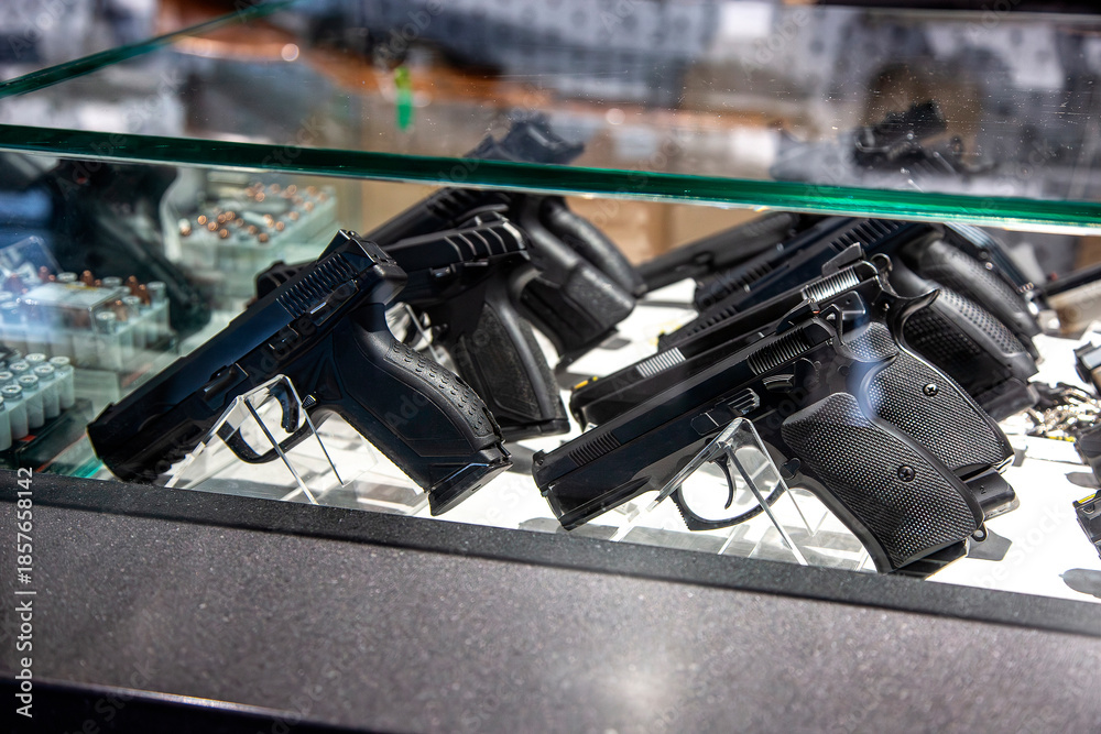 Handguns under glass in a display case